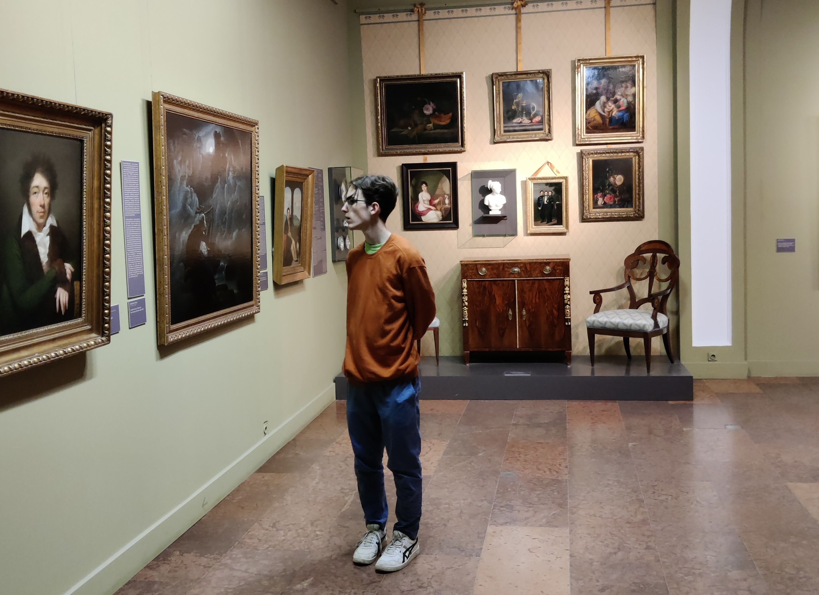 me looking at paintings in an art gallery